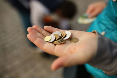 Midsection of child holding coins