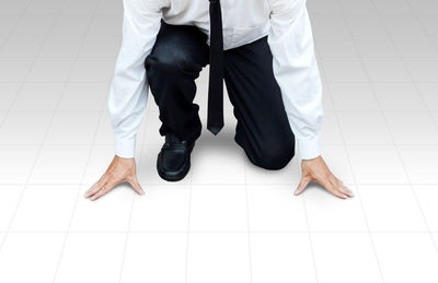 Low section of man on tiled floor