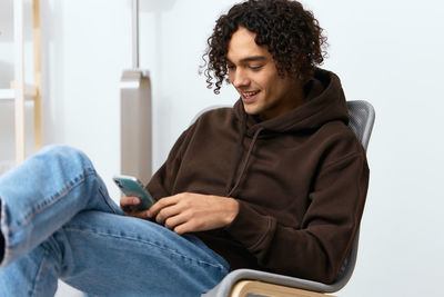 Young woman sitting on chair