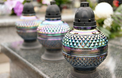 Three glass candles lit on grave in memory of dead loved ones on november 1 in poland