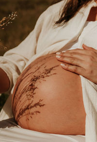 Midsection of woman with henna tattoo