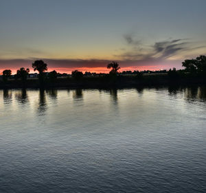 Scenic view of lake at sunset