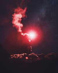 Silhouette man standing against sky at night