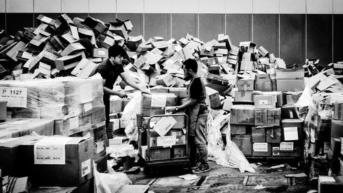 Men working with cardboard boxes at warehouse