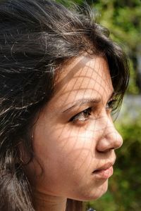 Close-up of a young woman in sunlight