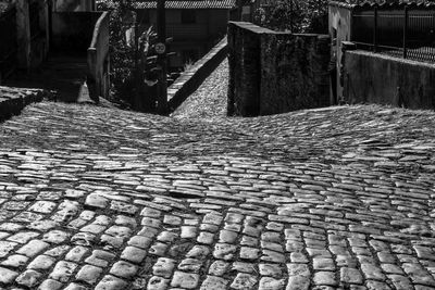 Cobblestone footpath by street in city