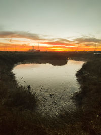 Scenic view of beach against sky during sunset
