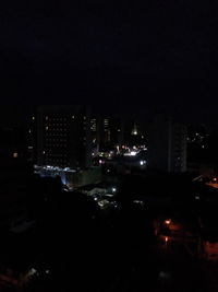 Illuminated cityscape against sky at night