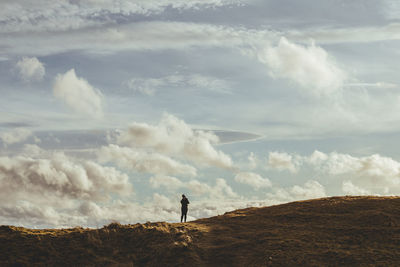 Man standing on land against sky