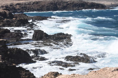 Waves splashing on rocks at shore