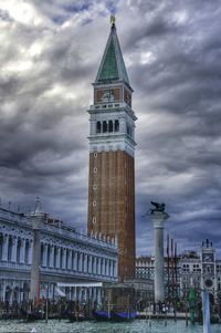 Low angle view of tower against cloudy sky