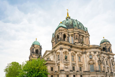 Low angle view of cathedral against cloudy sky