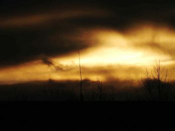 Silhouette of landscape against sky at sunset