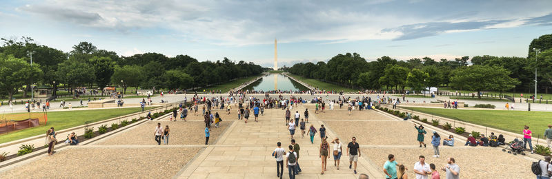 Group of people in park against sky