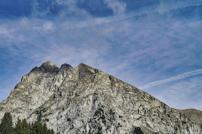 Low angle view of rock formation against sky