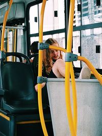 Portrait of woman sitting in bus