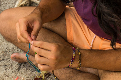 Midsection of woman hands on purple outdoors