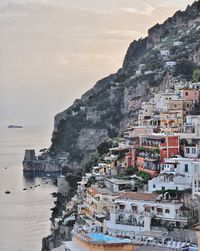 Townscape by sea against sky in town