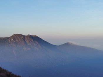 Scenic view of snowcapped mountains against clear sky