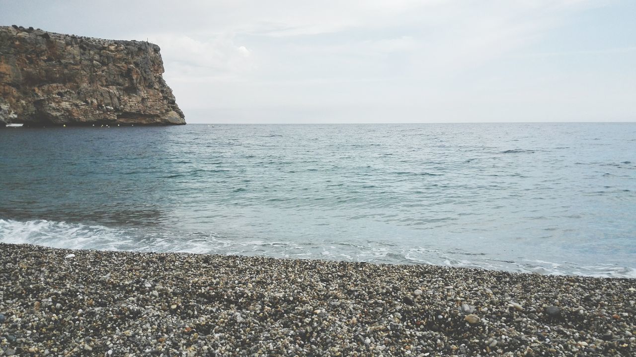 sea, horizon over water, water, beach, shore, tranquil scene, sky, scenics, tranquility, beauty in nature, nature, sand, coastline, idyllic, rock - object, remote, calm, wave, outdoors, seascape