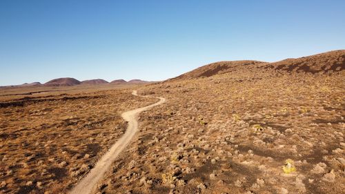 Scenic view of arid landscape against clear sky