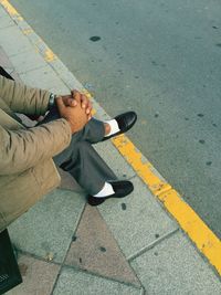 High angle view of man waiting at sidewalk