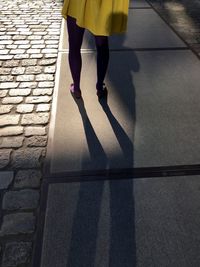 Low section of woman standing on tiled floor