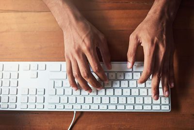 Cropped hands using laptop