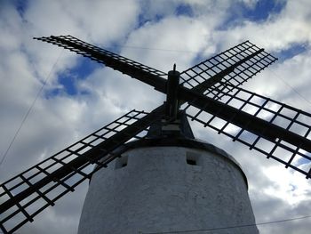 Low angle view of traditional windmill against sky