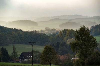 Scenic view of trees and mountains against sky