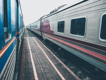 Train at railroad station platform against sky