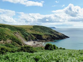 Scenic view of sea and coastline against sky