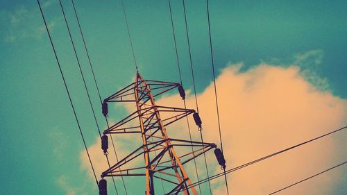 Low angle view of electricity pylon against sky