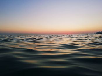 Scenic view of sea against clear sky during sunset