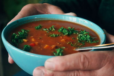 Midsection of man of holding soup bowl