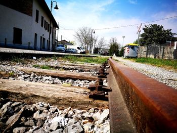 Railroad track by trees against sky