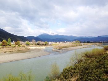 Scenic view of mountains against cloudy sky