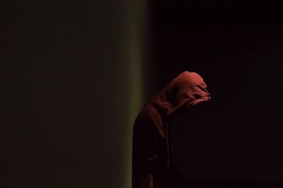 Low section of man against black background