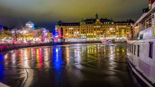 Illuminated buildings with waterfront at night
