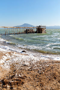 Pier over sea against clear sky