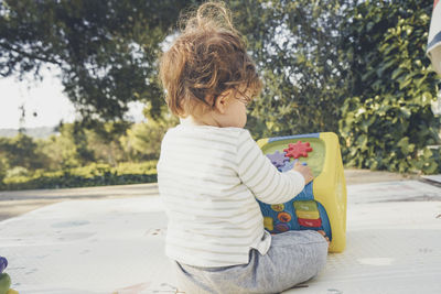Rear view of woman sitting outdoors