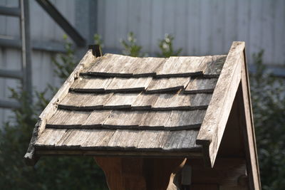 Wooden structure in yard against surrounding wall