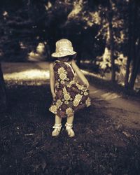 Rear view of woman walking on field