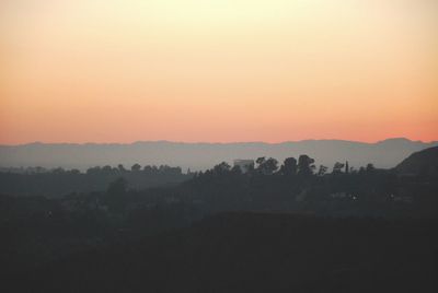 Scenic view of silhouette landscape against sky during sunset