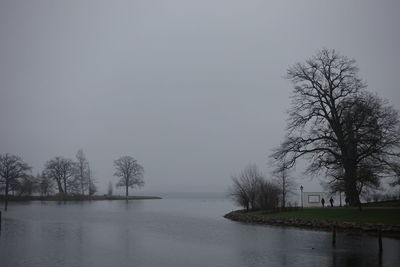 Scenic view of lake against sky during foggy weather