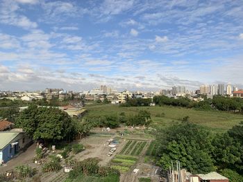 High angle view of street amidst buildings against sky