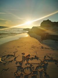 Scenic view of beach against sky during sunset