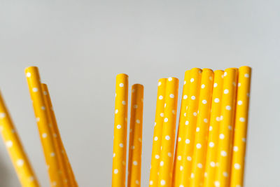 Close-up of yellow colored pencils against white background