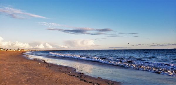 Scenic view of beach against sky during sunset