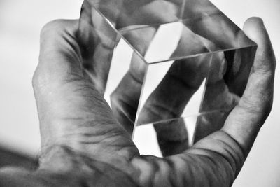 Cropped image of hand over white background